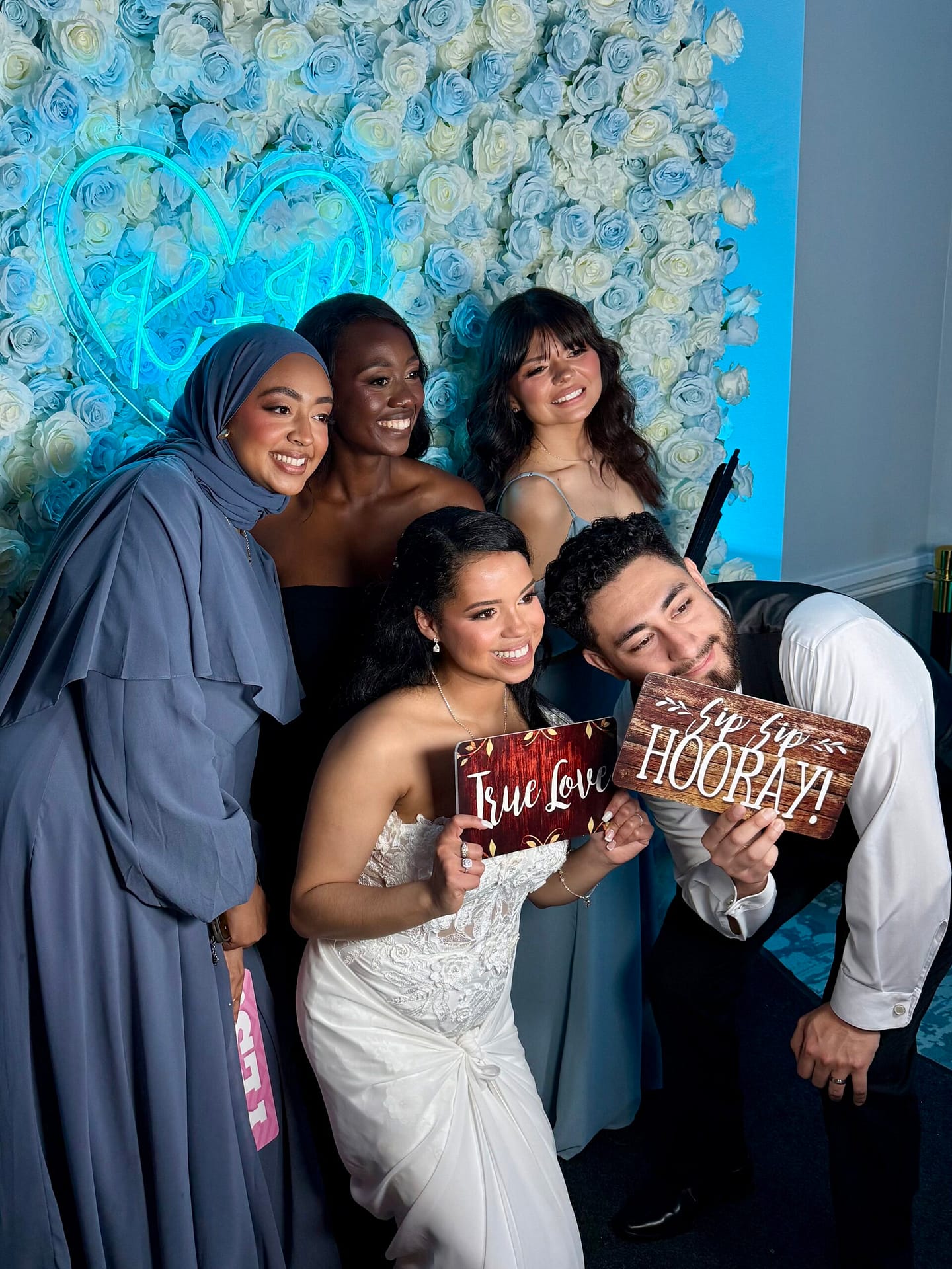 wedding guests using photo booth at reception